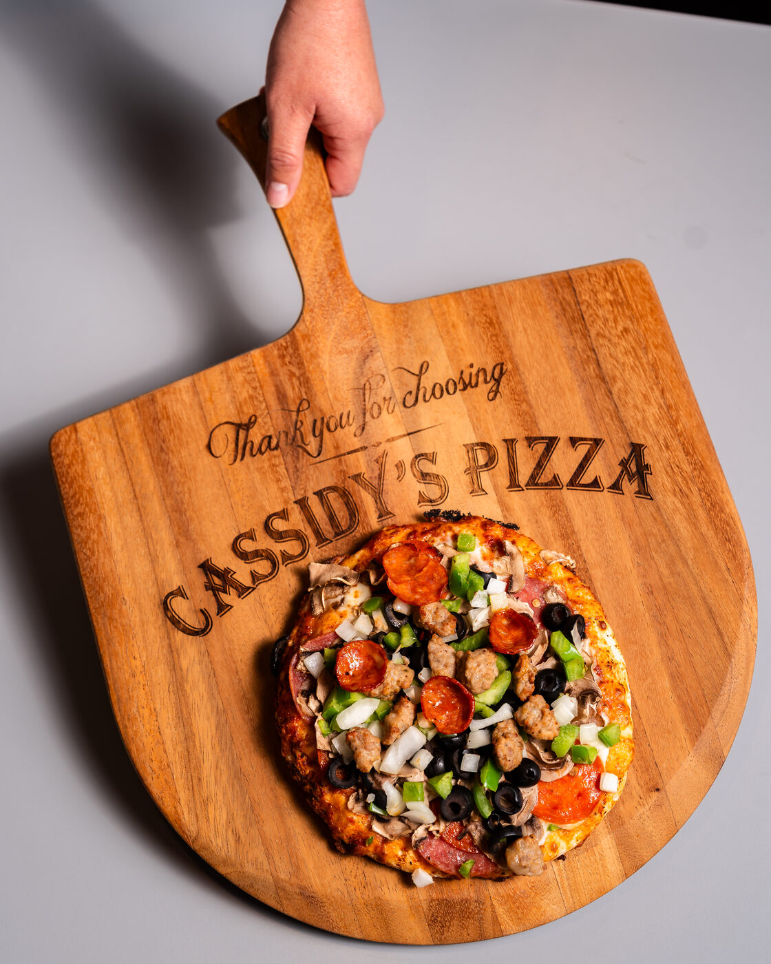 Cassidy's Pizza employee serving fresh pizza